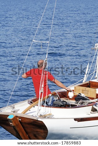 Sailor pulling rope on a boat in navigation