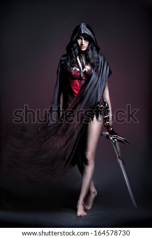 Photo Session In Studio Of The Young Girl In Style Art With An Unusual Makeup Ã?Â  Girl In Cloak And Sword