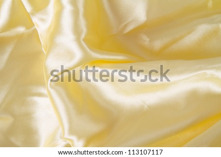 Abstract yellow background fabric,cloth, silk texture satin or velvet material.