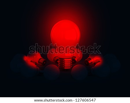 Red glowing light bulb lamp illuminates on dark.