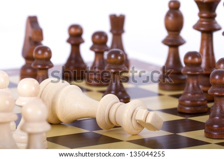King get lost the game against opponent on chess board, isolated on white background.