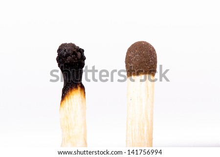 Burned match stick and normal match, isolated on white background.