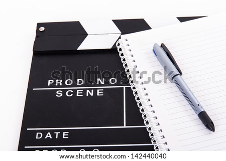 Black cinema clapper board and notebook for scenario with pen, isolated on white background.