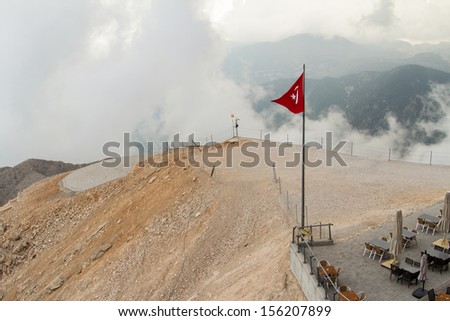 High view of landscape, foggy mountain and cloudy weather with wavy Turkey flag.