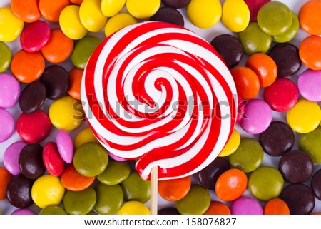 Colorful spiral lollipop candy on stick.
