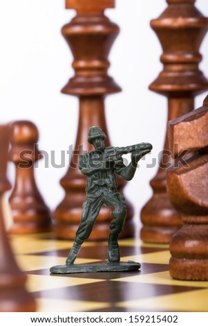 Close up view of miniature toy soldier on chess board.