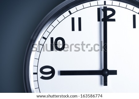 Time concept. Close up view of clock on wall with copy space, time to work.
