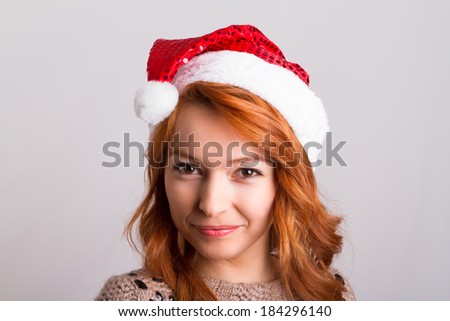 Young pretty red head woman wearing christmas hat with smiling emotion, expression in her face, isolated on white background.