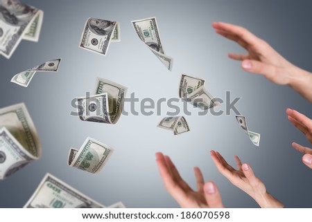 One hundred dollar money banknotes flying and falling on young male hands.