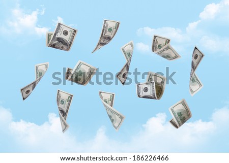Dollar banknotes falling down on cloudy sky background.