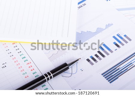 Finance concept, financial and stock market graphs, charts analysis on business table.
