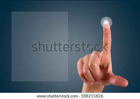 Young female hand finger touching or pressing on digital screen on dark background with copy space area.