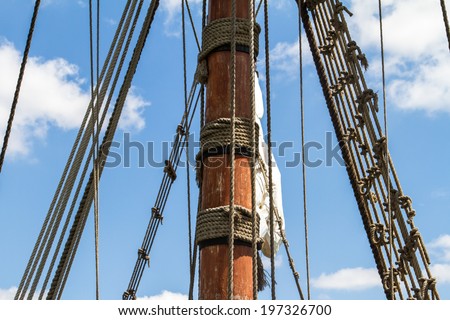 Close up view of pirate ship, sailing boat on cloudy background.