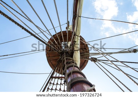 Close up view of pirate ship, sailing boat on cloudy background.