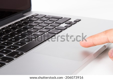 Hand finger using touch pad on laptop, isolated on white background.