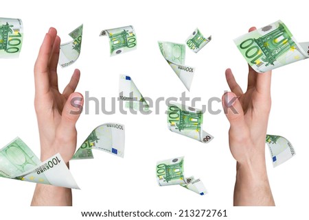 One hundred euro money banknotes flying and falling on young male hands, isolated on white background.