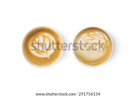 Top view of two latte art coffees with heart figure, isolated on white background.