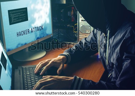 anonymous hacker with no face in the darkness, breaks the access to steal information and infect computers and systems. the concept of hacking and cyber war
