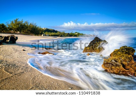 Waves lapping on the sandy beach at Boucan Canot on Reunion Island in the Indian Ocean.