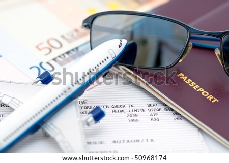 Closeup image with toy airplane, sunglasses,passport books, tickets and euro cash for travel concept
