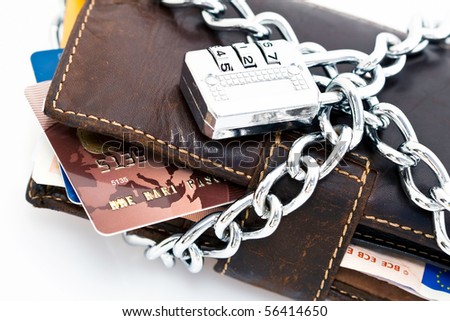 Leather wallet with credit cards and Euro currency locked with a chain and combination lock.