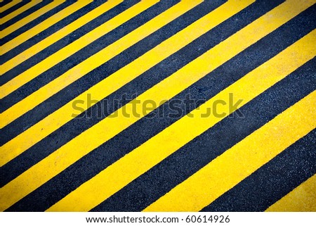 Abstract background of yellow stripes on black asphalt road surface