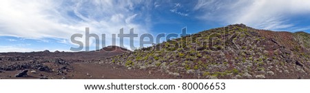 Panoramic view of volcanic landscape of Reunion Islands with blue sky and cloudscape background.
