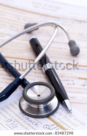 Stethoscope and pen on top of hand-written doctor\'s notes and forms.