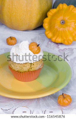 Sweet pumpkin muffin with three marzipan pumpkins