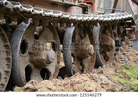 Part of old caterpillar Tractor with mud