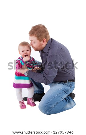 Red haired father calms his small crying daughter, isolated on white
