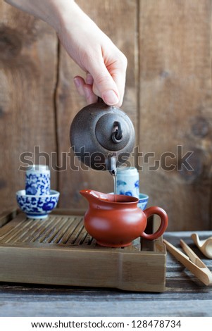 Traditional chinese tea ceremony accessories, Pouring tea from teapot, on the tea table