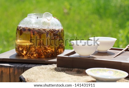 Traditional Chinese tea ceremony, tea leaves in boiling water in a glass pot, selective focus