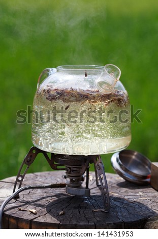 Traditional Chinese tea ceremony, tea leaves in boiling water in a glass pot, selective focus