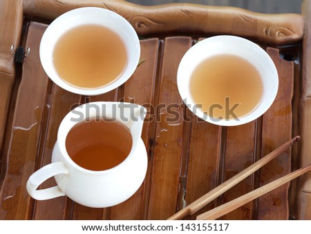 Traditional chinese tea ceremony accessories (tea cups) on the tea table, selective focus
