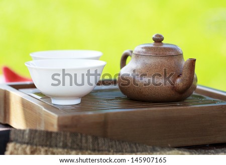 Traditional chinese tea ceremony accessories (tea pot and tea pair) on the tea table, selective focus