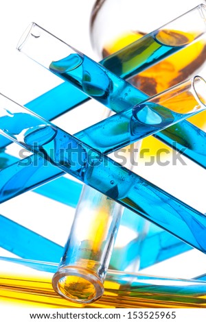 test tubes with colored liquid (yellow and blue) on a white background, close-up