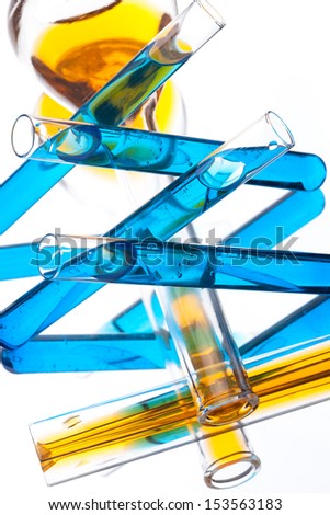 test tubes with colored liquid (yellow and blue) on a white background, close-up
