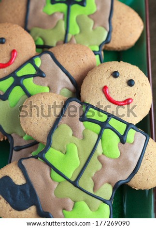 Homemade Gingerbread men in protective khaki uniforms on Defender of the Fatherland Day, close up, selective focus on the right man