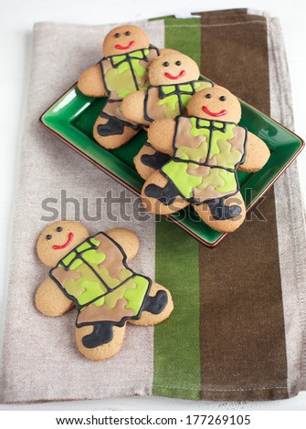 Homemade Gingerbread men in protective khaki uniforms on Defender of the Fatherland Day, selective focus on the right man