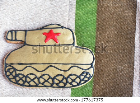 homemade Gingerbread tank with a red star on the Defender of the Fatherland Day with place for text, selective focus