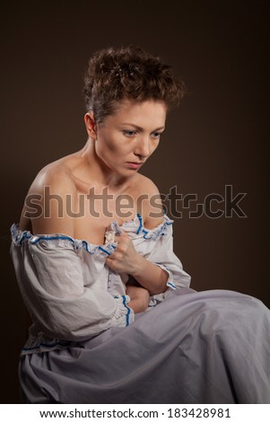 Girl in the image of a poor peasant with the suffering on her face, actress
