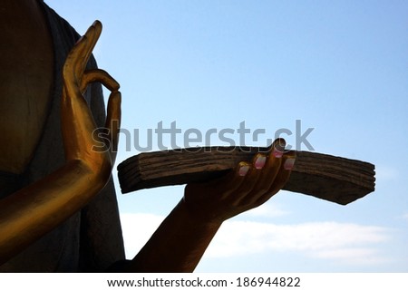 Buddha statue hans on blue sky background with clipping path and