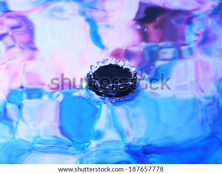 Photo art, splash like a crown, colorful background in blue and pink colors, selective focus