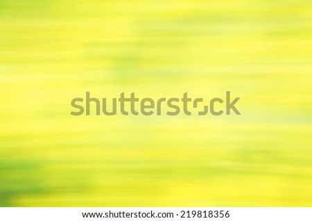 Photo art, bright Colorful light streaks abstract background in yellow and green colors, effect of movement