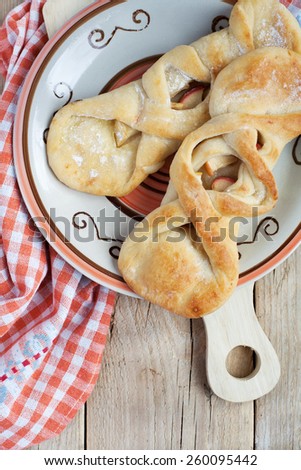 Homemade cakes with apple on a wooden table with orange towel, selective focus