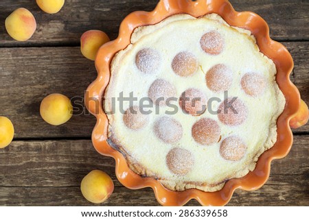 Cake with cottage cheese, apricots and puff pastry on wooden table, selective focus