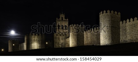 Night view of the medieval city walls in the city of Avila in central Spain.