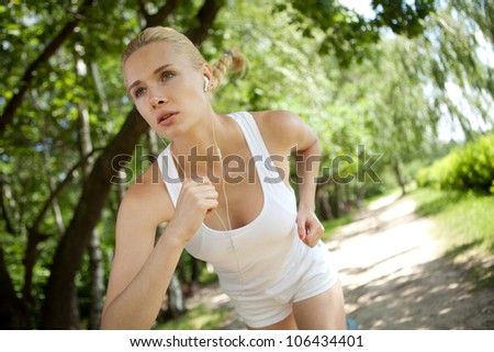 Running woman in park in summer training.