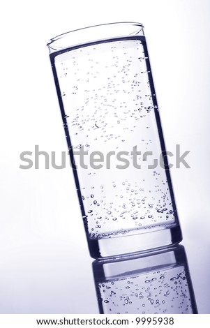 Glass whith still water on light background